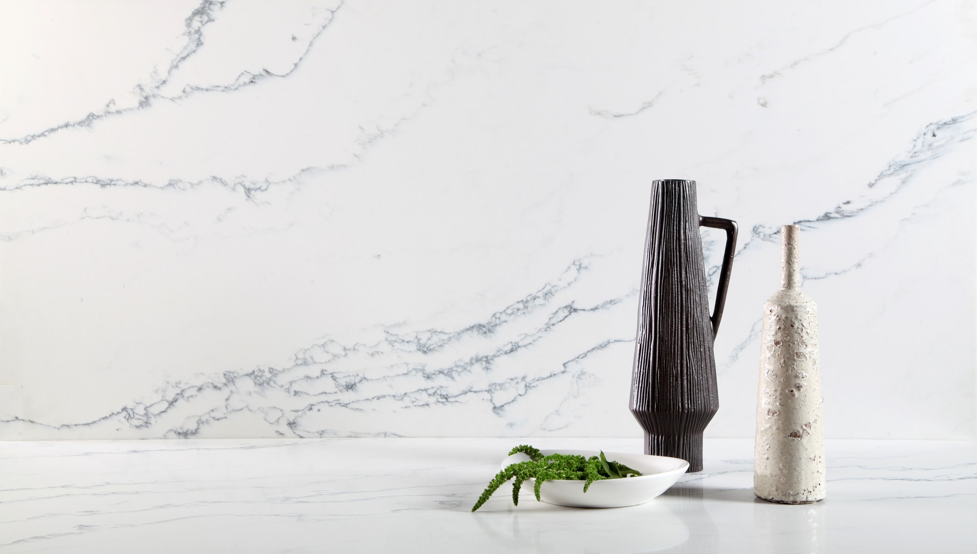 Marble kitchen counter top with pitcher of water and bowl