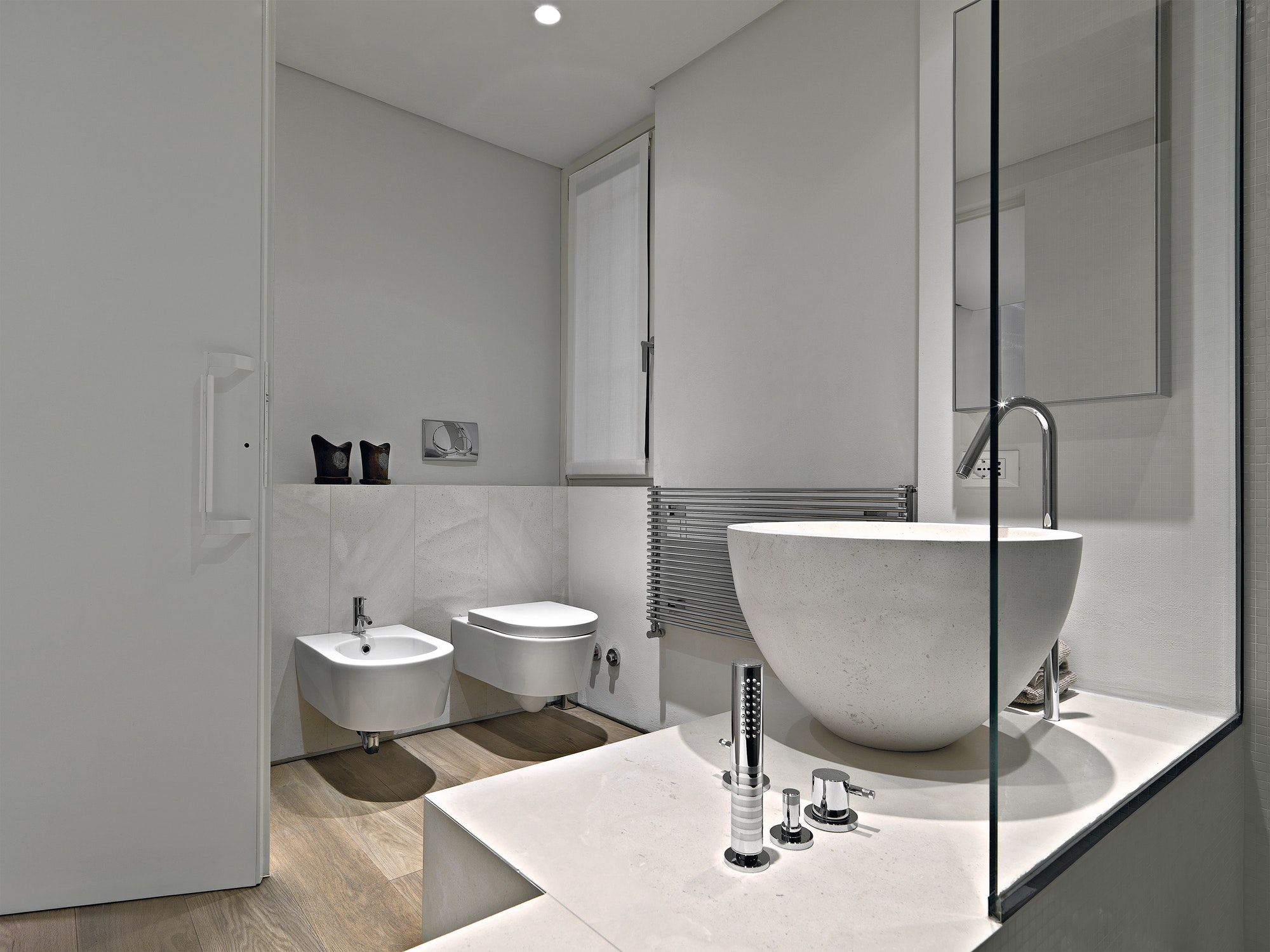 Modern Bathroom Interior in the Foreground there is a Marble Countertop Washbasin